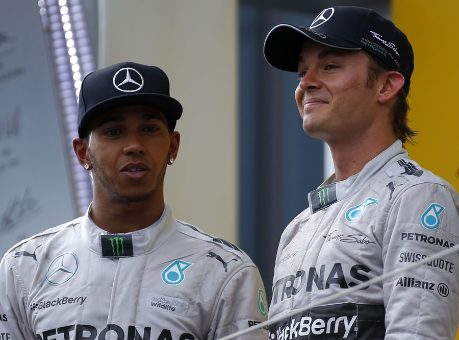 Nico Rosberg and Lewis Hamilton stand on the podium after securing a Mercedes one-two
