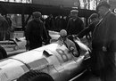 Richard Seaman at the wheel of his Mercedes W154 with team boss Alfred Neubauer watching on