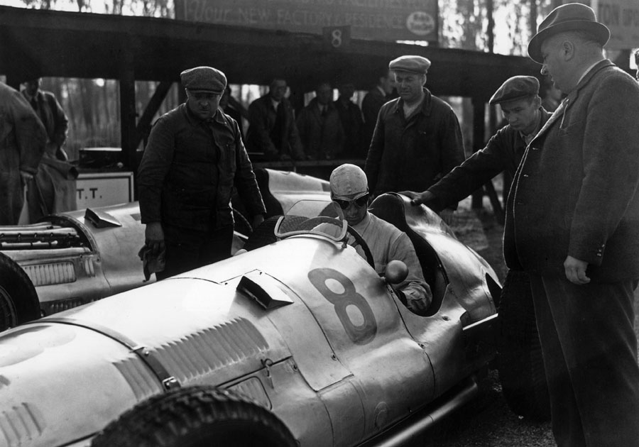 Richard Seaman at the wheel of his Mercedes W154 with team boss Alfred Neubauer watching on