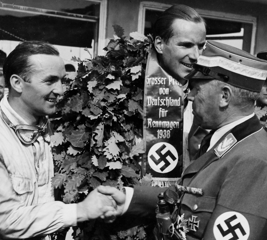 Richard Seaman on top of the podium after winning the German Grand Prix ahead of Hermann Lang 