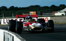 Jochen Rindt lifts a wheel on his way through Becketts