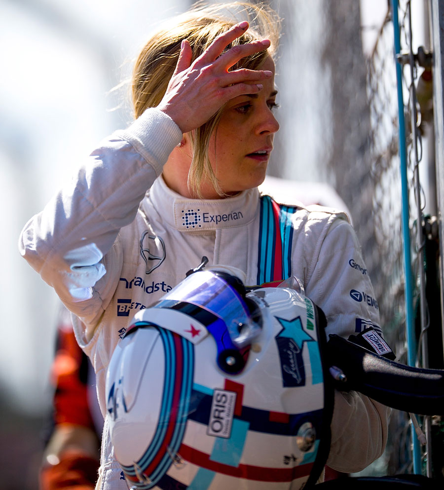 Susie Wolff walks from her stricken Williams after her debut F1 session ended after four laps