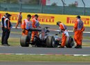 Stewards prepare to remove Lewis Hamilton's stricken Mercedes in FP2