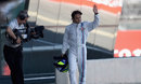 Felipe Massa acknowledges the crowd as he walks back to the pits following his FP1 crash