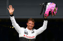 Jenson Button acknowledges the home crowd after claiming third on the grid