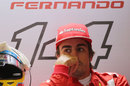 Fernando Alonso sits in his garage during qualifying