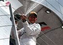 Lewis Hamilton sprays champagne to celebrate victory on the podium