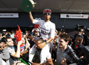 Lewis Hamilton celebrates with his Mercedes mechanics in the pit lane
