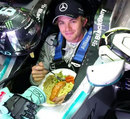 Nico Rosberg grabs a spot of lunch in the cockpit of his Mercedes