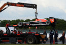 Jules Bianchi's Marussia is lifted onto a flatbed truck after a small fire stopped it on track