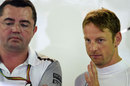 McLaren racing director Eric Boullier and Jenson Button talk in the paddock