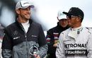 Jenson Button and Lewis Hamilton share a joke on the drivers' parade