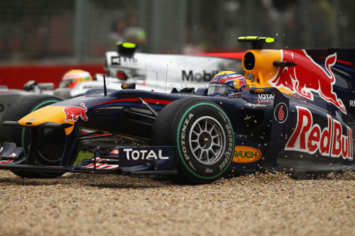Mark Webber ends up in the gravel as Lewis Hamilton slips by
