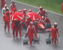 Soggy Ferrari mechanics head back to the pits