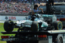 The wrecked Mercedes of Lewis Hamilton is removed from the track after his accident 