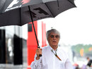 Bernie Ecclestone arrives in a wet paddock on Sunday morning