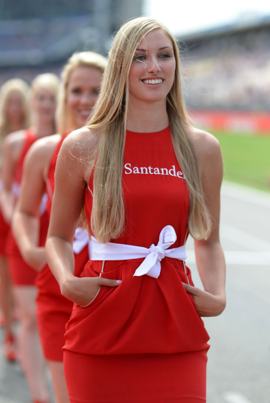 A grid girl on track ahead of the start of the race