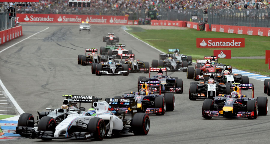 Kevin Magnussen and Felipe Massa go wheel-to-wheel through Turn 1