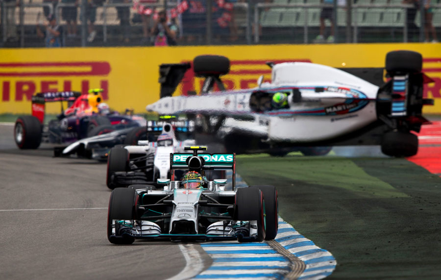 Nico Rosberg leads as Felipe Massa gets flipped upside-down behind him