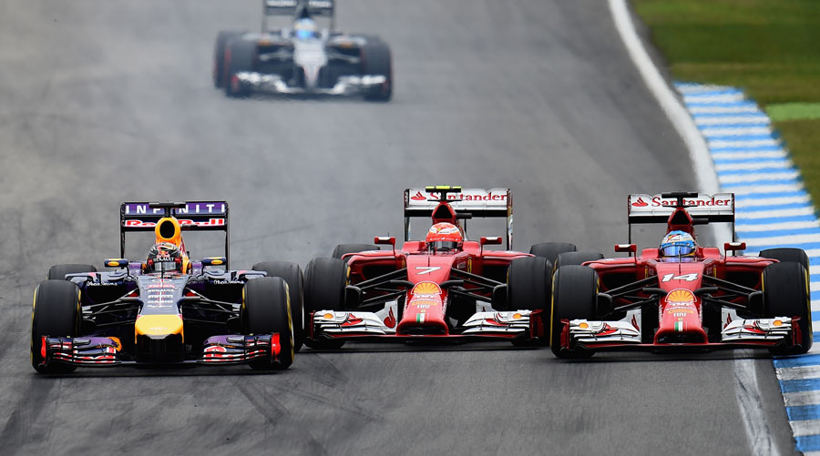 Sebastian Vettel passes both Kimi Raikkonen and Fernando Alonso on the inside of Turn 6