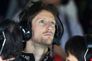 Romain Grosjean looks on in the garage
