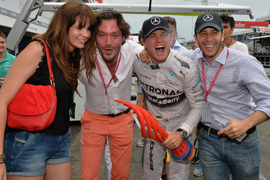 Nico Rosberg celebrates victory with friends outside the Mercedes garage
