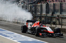 Max Chilton returns to the pits with smoke coming from the rear of his Marussia