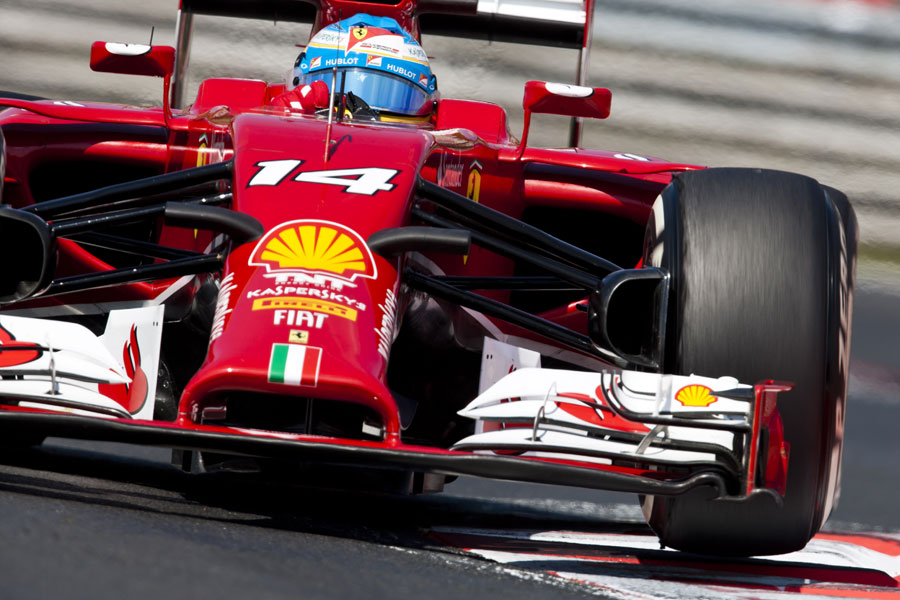 Fernando Alonso hops across the kerbs in his Ferrari
