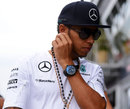 Lewis Hamilton walks through the paddock on Sunday