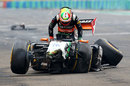 Sergio Perez clambers from his wrecked Force India