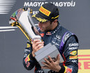 Daniel Ricciardo kisses the winners' trophy on the podium