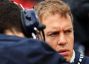 Sebastian Vettel talks to his engineer on the grid