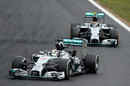 Lewis Hamilton driving with Nico Rosberg in close company