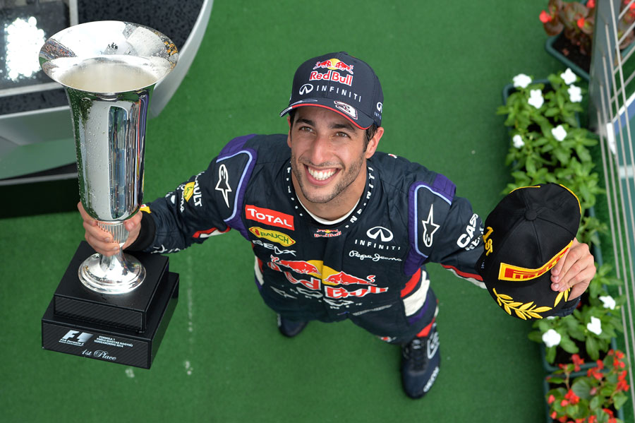 Daniel Ricciardo poses for photographs on the podium