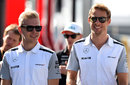 Kevin Magnussen and Jenson Button walk through the paddock