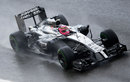 Jenson Button navigates through the wet conditions 