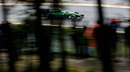 A view of Caterham debutant Andre Lotterer through the trees