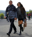 Jenson Button arrives in the paddock with fiancée Jessica Michibata 