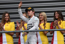 Nico Rosberg waves to the fans as he arrives on the podium