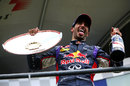 Daniel Ricciardo celebrates with the winner's trophy and champagne on the podium
