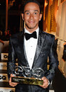 Lewis Hamilton poses with his award after being named GQ's Sportsman of the Year