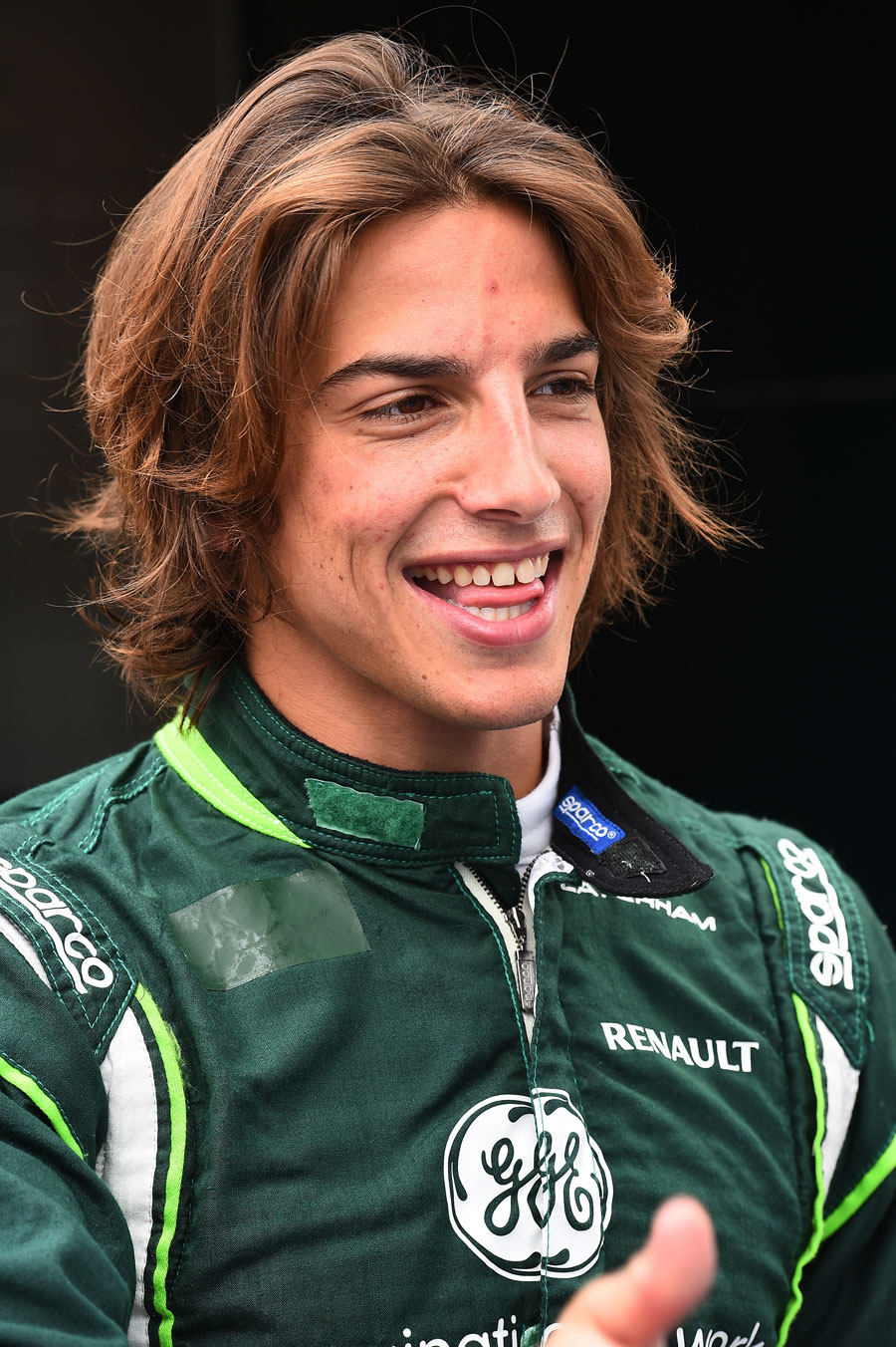 Roberto Merhi poses for the cameras in Caterham gear ahead of his debut F1 practice session