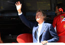 Luca di Montezemolo waves to the fans from the Ferrari pit wall