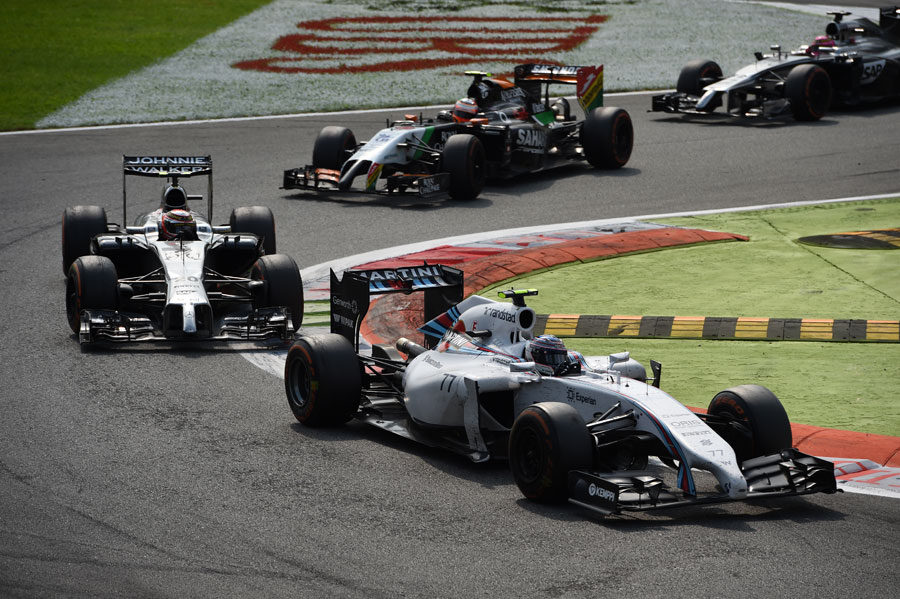 Valtteri Bottas leads Kevin Magnussen and Sergio Perez through the Rettifilo