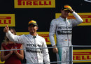 Nico Rosberg looks on as Lewis Hamilton takes to the podium