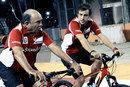 Santander boss Emilio Botin cycles the track with Fernando Alonso