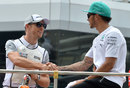 Jenson Button shakes hands with former team-mate Lewis Hamilton