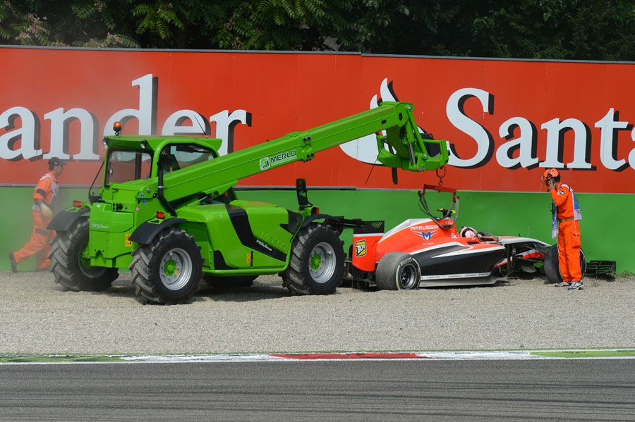 Max Chilton's stricken Marussia is recovered after he retired in the gravel at Roggia 