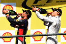 Daniel Ricciardo and Valtteri Bottas sip champagne on the podium