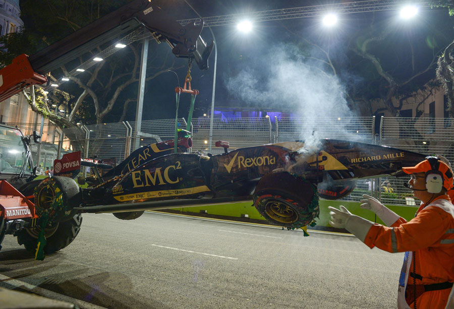Pastor Maldonado's stricken Lotus is removed from track during FP2
